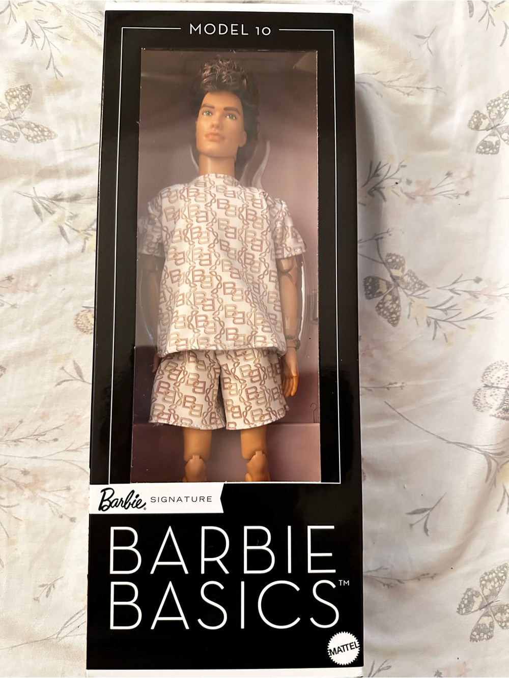 Mattel Barbie Basics Male Doll in White and Beige Monogram Outfit